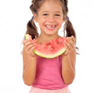 Little girl eating watermelon, studio shoot Little girl eating watermelon, studio shoot